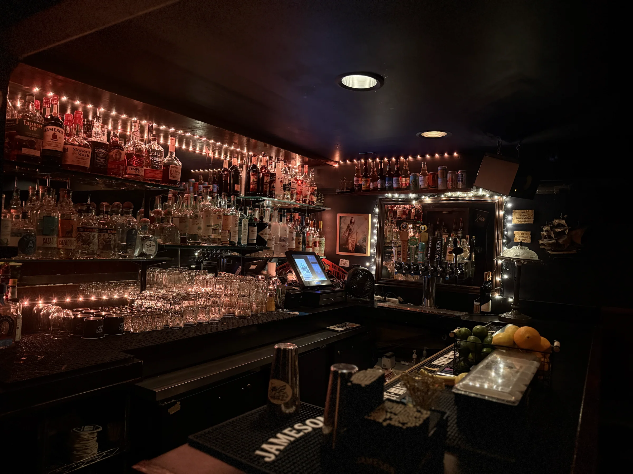 The private downstairs bar with bottles displayed behind it